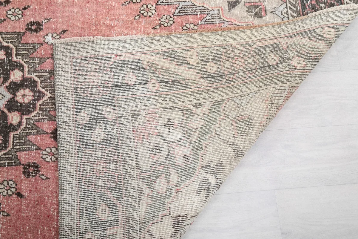 Close-up of the rug's underside, showing the knotting and the texture of the cotton foundation