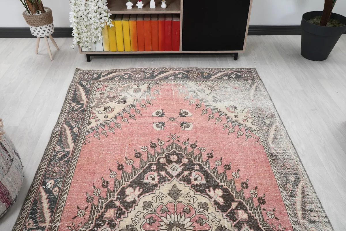 Overhead view of the vintage rug, capturing the full pattern and color scheme in a room setting