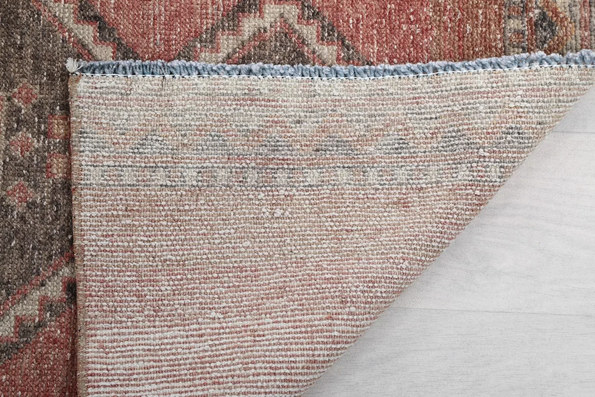 Underside of the hand-knotted vintage rug, showing the consistent weave and cotton foundation