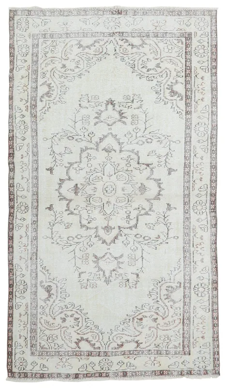 Full overhead view of the vintage Anatolian rug with a cream field and brown medallion.