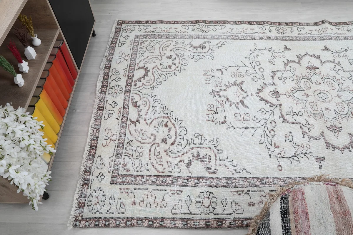 View of the rug from an angle, showcasing its full length and the consistent pattern across the field.