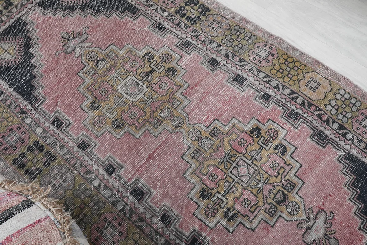 Overhead angle showing the faded pink field and intricate geometric motifs