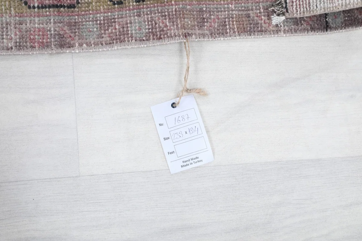 Product tag attached to the rug, displaying information about its origin and material