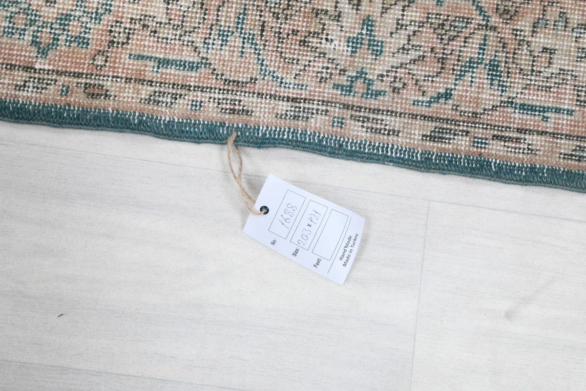 Rug's edge with a product tag, displaying information about the item