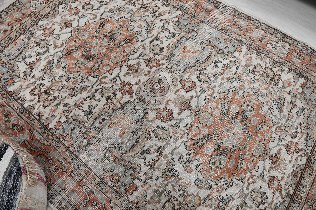 Cream Orange Floral Anatolian Rug close-up of the distressed floral motifs and texture.