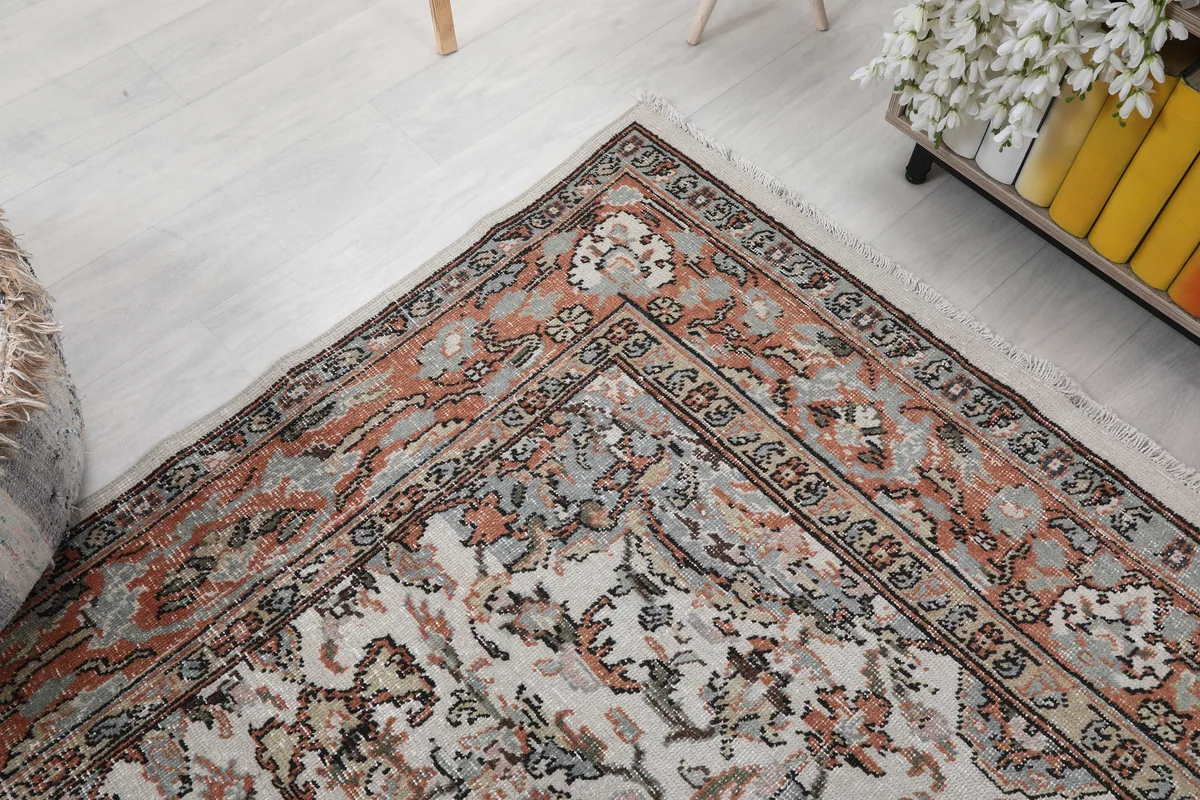 Cream Orange Floral Anatolian Rug close-up of a corner, revealing the faded orange and gray tones.