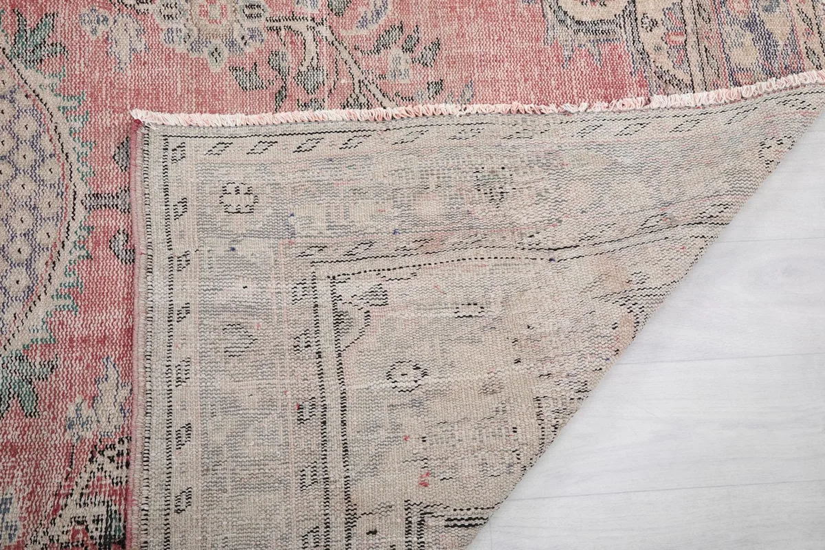 Underside of the rug showing the reverse of the hand-knotting and foundation