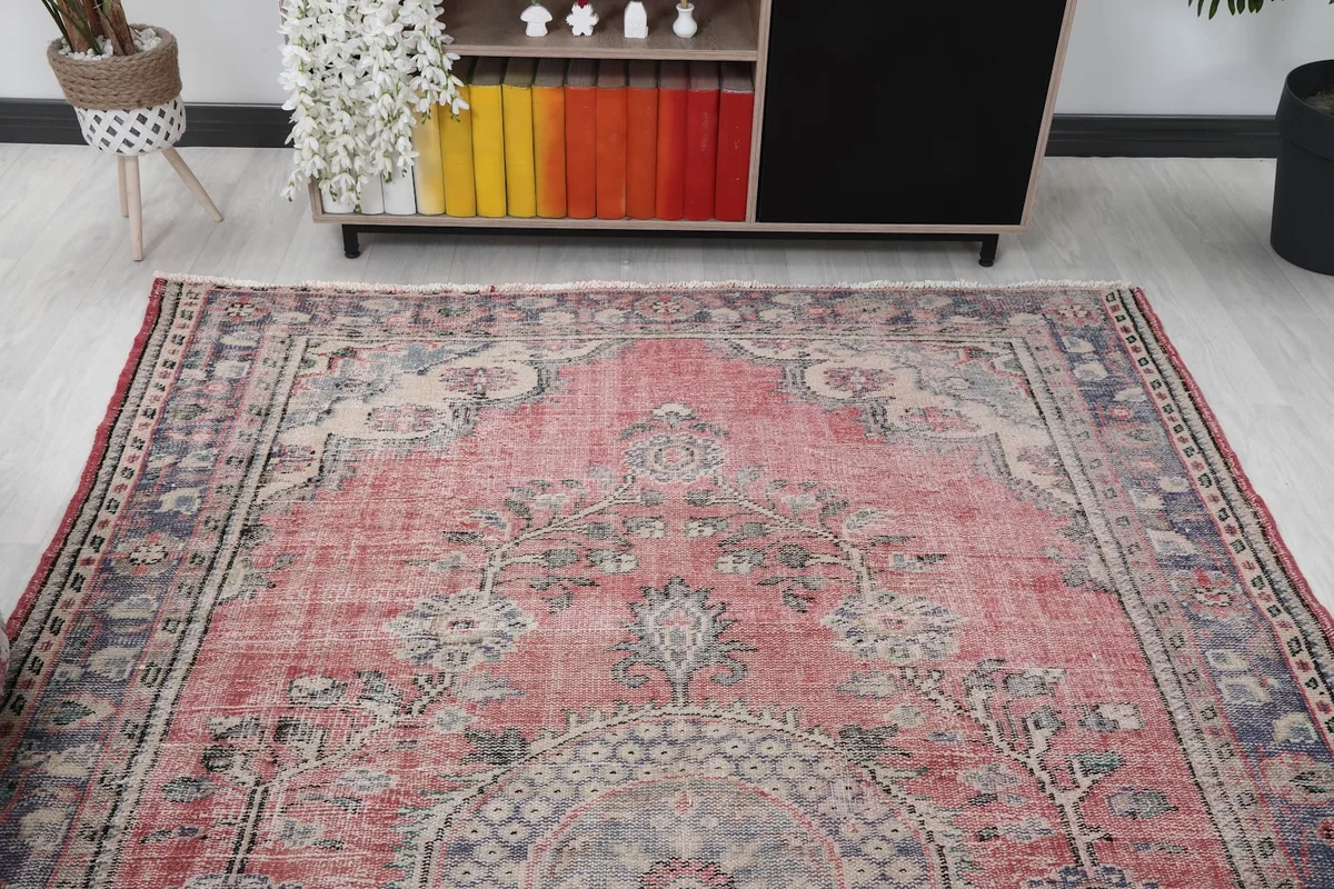 Overhead view of the vintage rug in a room, highlighting its placement and scale