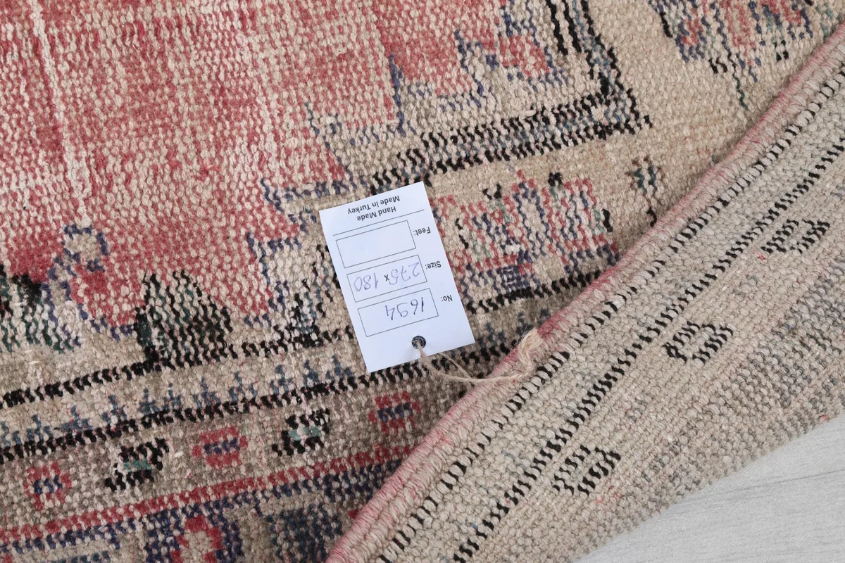 Tag on the back of the rug indicating its dimensions and details