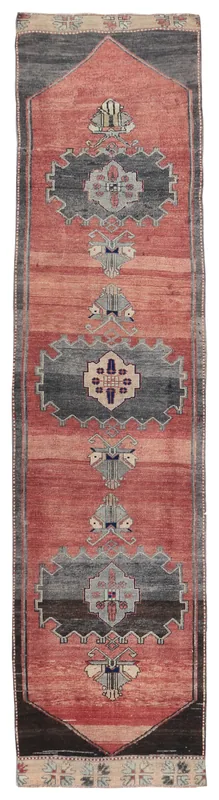 Full overhead view of the rust and gray geometric Anatolian runner on a white background
