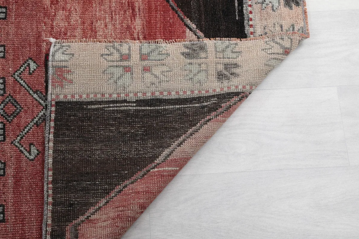 Another view of the rug's underside and fringe, showing the hand-knotted construction