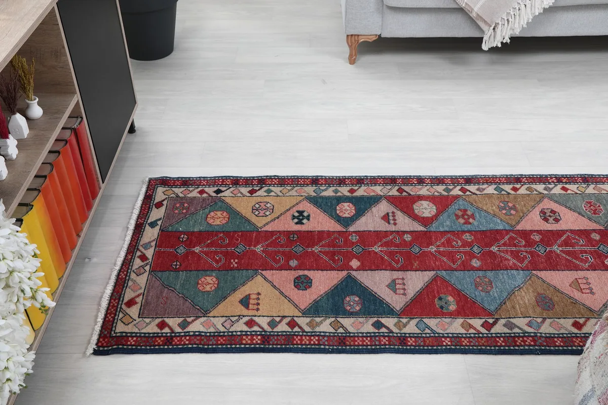 View of the runner rug extending across a room, from a slightly elevated perspective