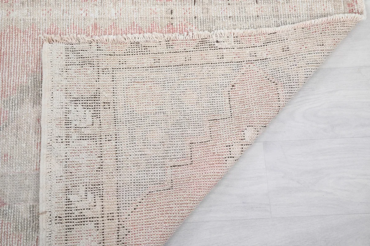 Another view of the rug's back, showing the craftsmanship and condition of the foundation.