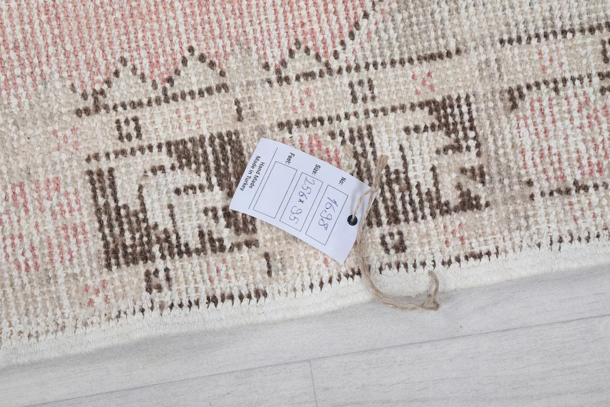 Close-up of the rug's corner with the product tag, showing details of the weave.