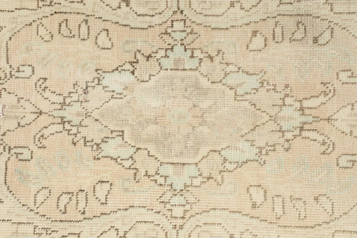 Close-up of a section of the rug's pattern, showing the intricate hand-knotted details and color variations.