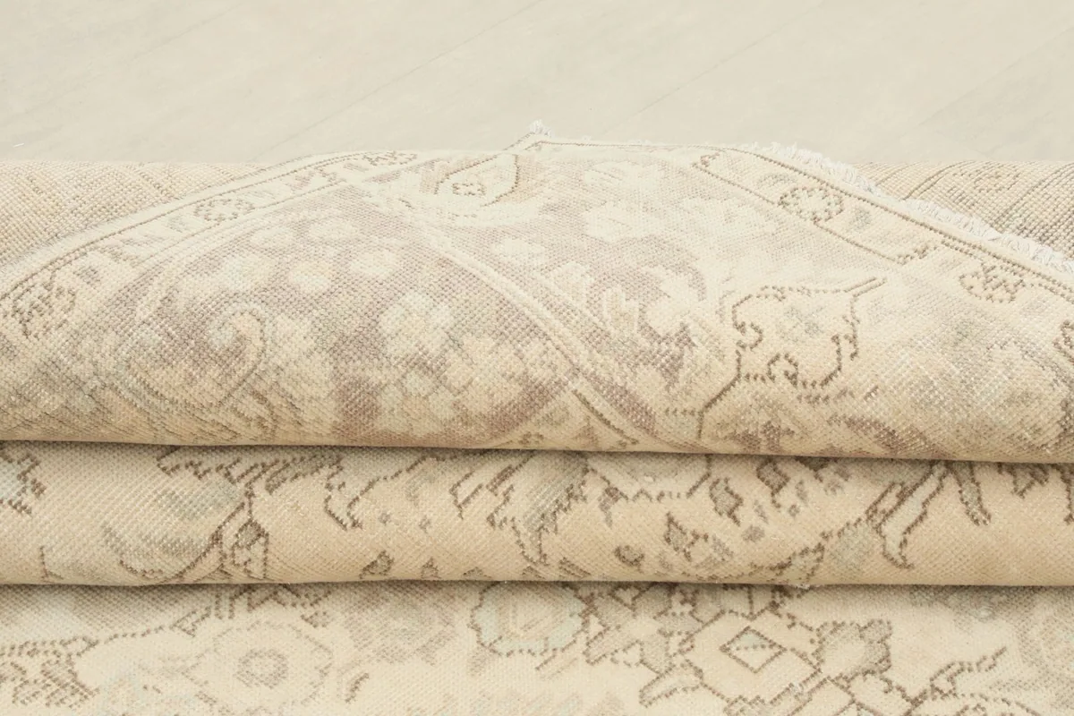 Stacked view of the folded rug, highlighting the texture and various patterns visible from the side.