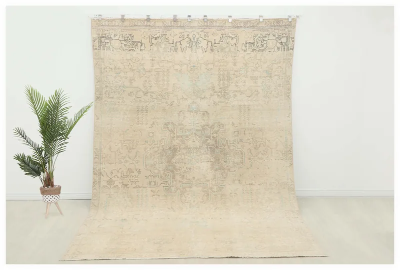 Full overhead view of the 7'6" x 11'4" cream and gray vintage Anatolian area rug on a white background