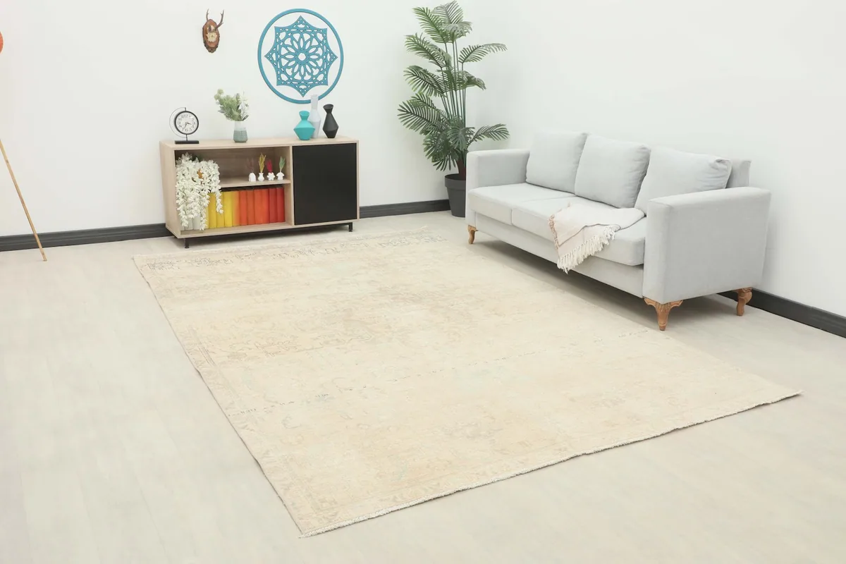 Angled view of the cream and gray rug in a living room, showing its scale relative to furniture