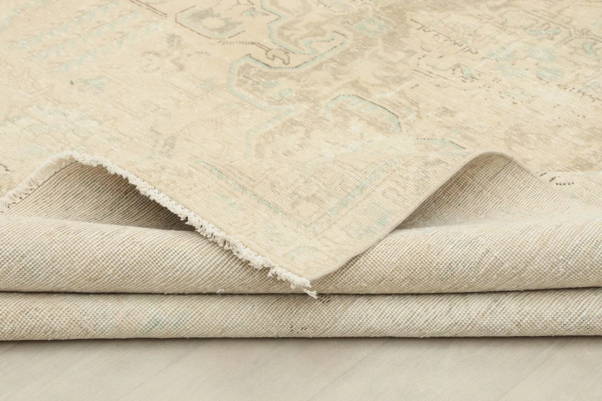 View of the rug folded, showing the thickness of the wool pile and cotton foundation