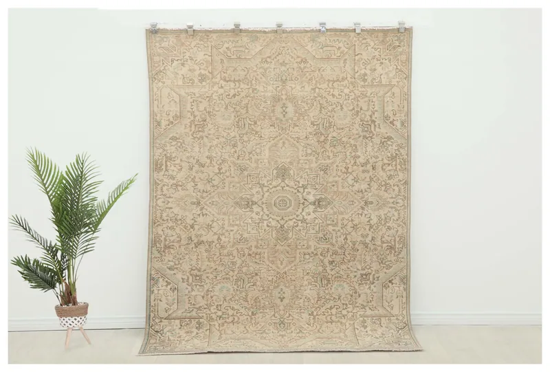 Full top view of the beige vintage Anatolian wool rug with a central medallion on a white background