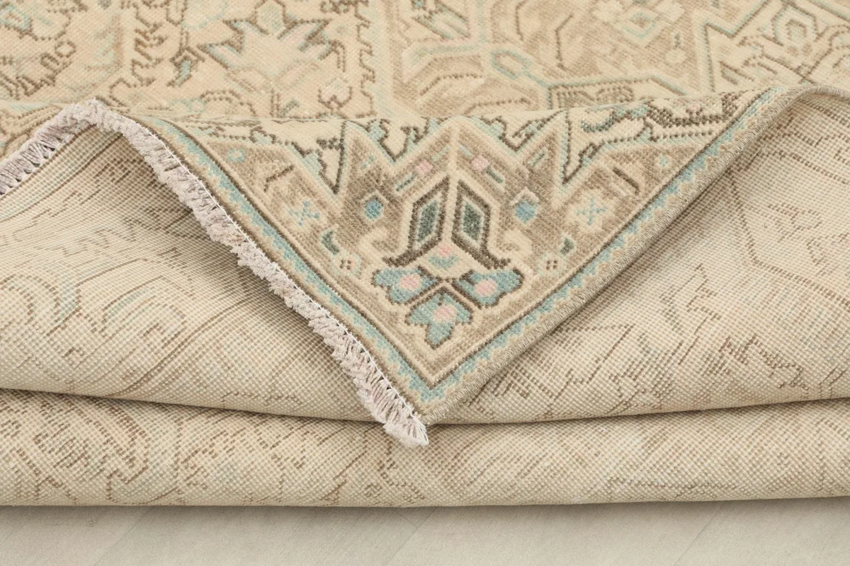 View of the rug folded to show the back and the consistent hand-knotted weave