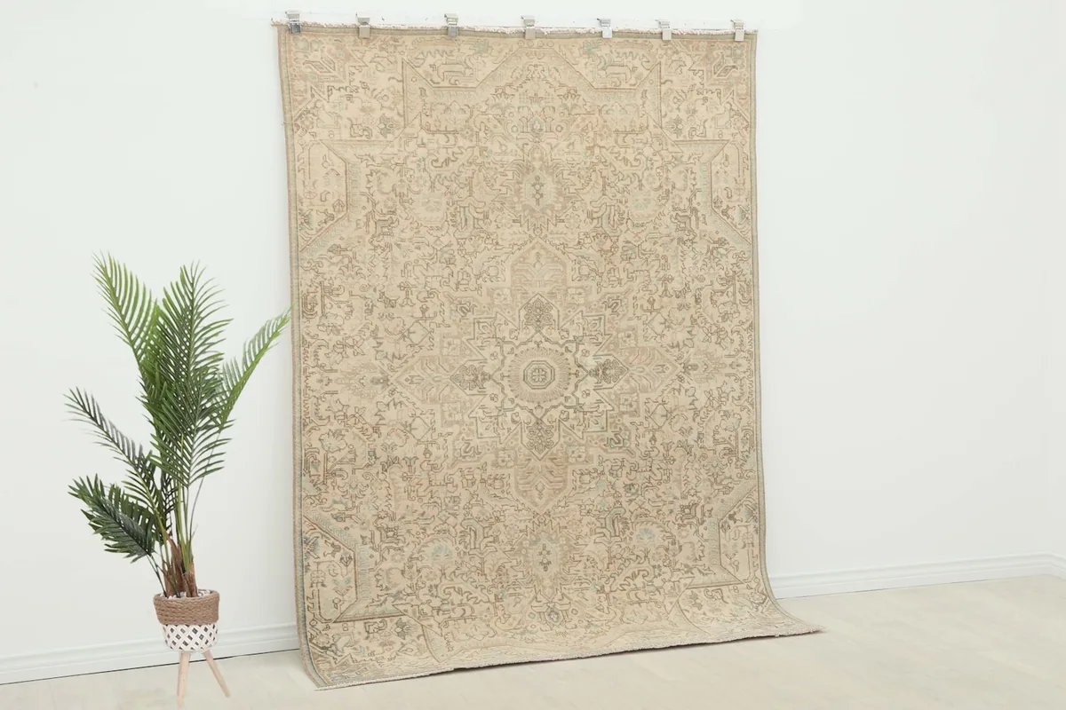 Overhead view of the beige vintage rug, showing its full design and subtle color variations