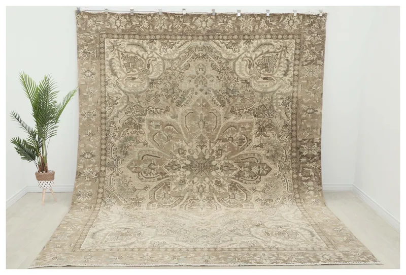 Full top view of the 9'4" x 12'5" beige and gray vintage Anatolian area rug on a white background.
