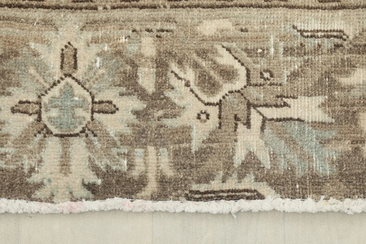 Close-up of the low pile and texture, revealing the hand-knotted wool and vintage wear.