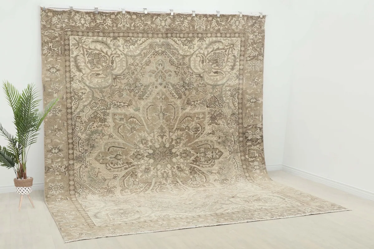 Overhead view of the beige and gray vintage rug, showing its full design and muted tones.