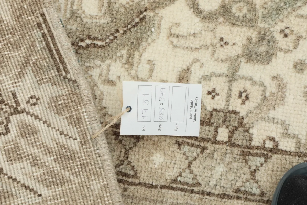 Rug tag displaying size and origin information, placed on the rug's surface.