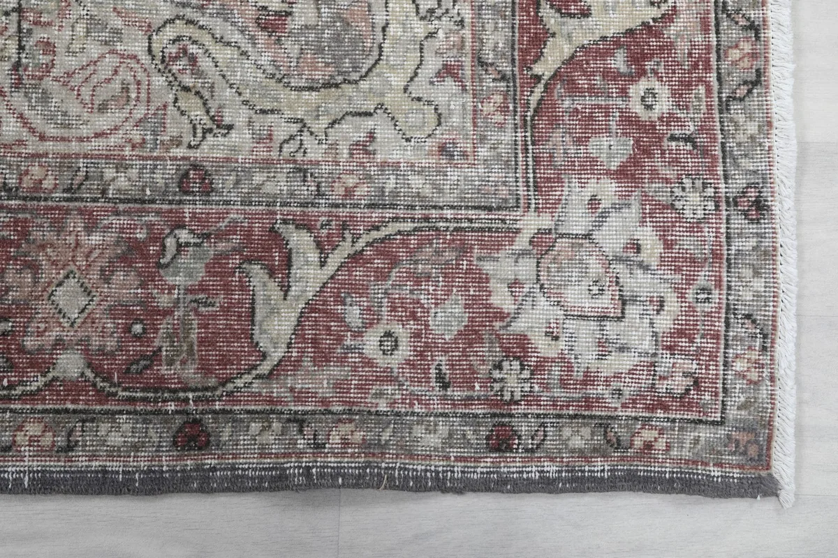 Detail of the rose-colored floral border and corner design