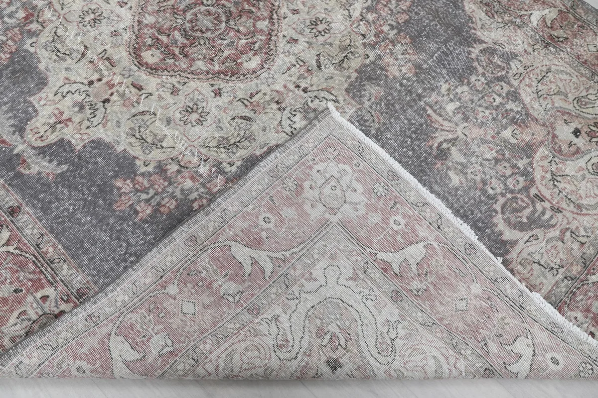 View of the back of the rug, showing the cotton foundation and knotting