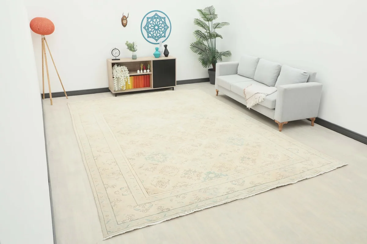 Angled view of the large rug in a room, showing its scale relative to furniture and decor