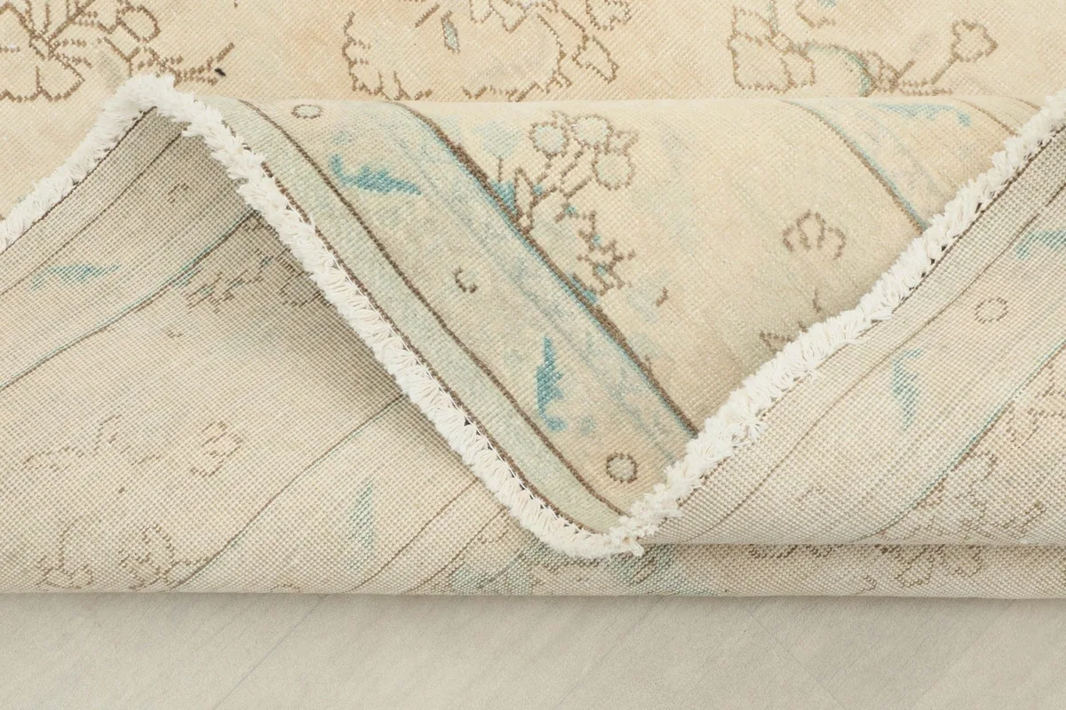 Close view of the rug's low pile and the tight hand-knotting, highlighting its vintage character