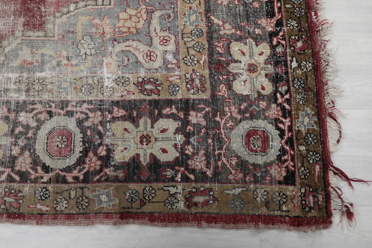 Close-up of the intricate black and beige border with floral and geometric patterns