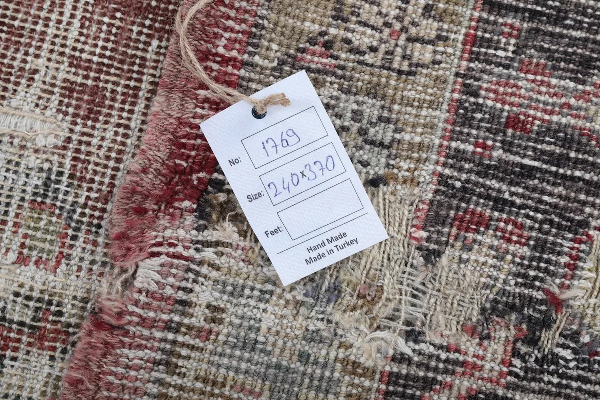 Back of the rug showing the hand-knotted construction and a size tag