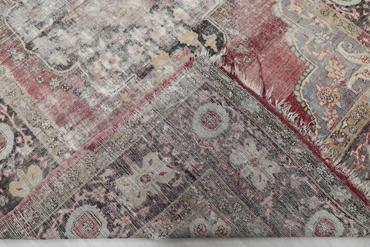 Folded corner of the rug, revealing the back of the hand-knotted wool and cotton foundation