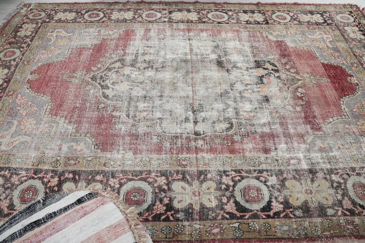 Overhead view of the rug's surface, capturing the distressed texture and color variations