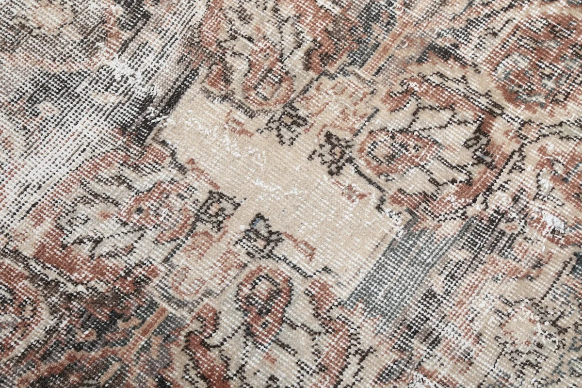 Textured close-up of the low wool pile and distressed areas