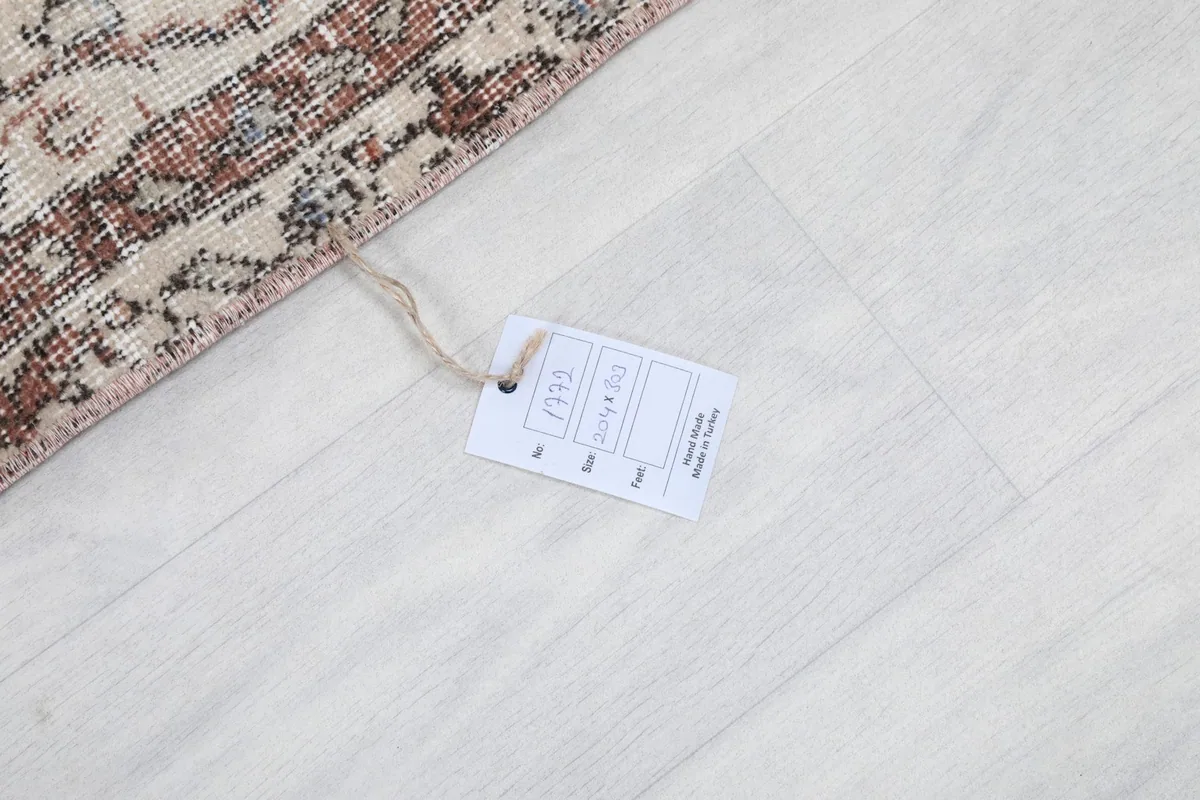 Product tag attached to the rug, showing item details and origin
