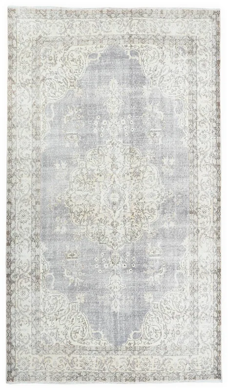 Full overhead view of the 6'7" x 9'9" gray vintage Anatolian rug with ivory medallion and border.