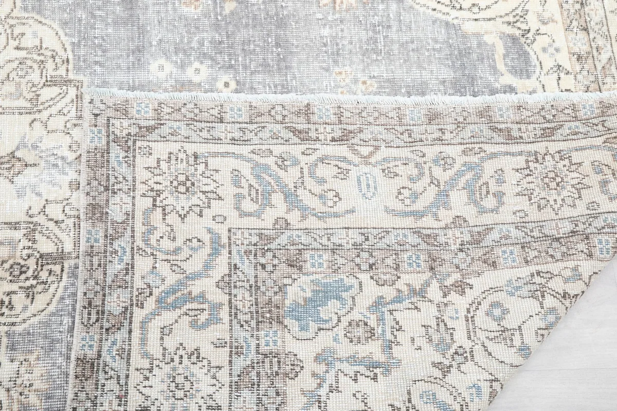 Close-up of the rug's reverse side, showing the tight knotting and foundation.