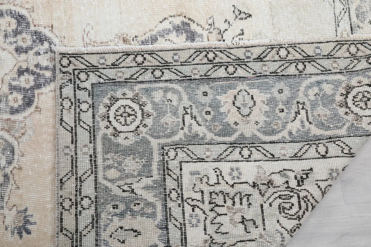 Another folded corner view, showing the hand-knotted construction and border details.