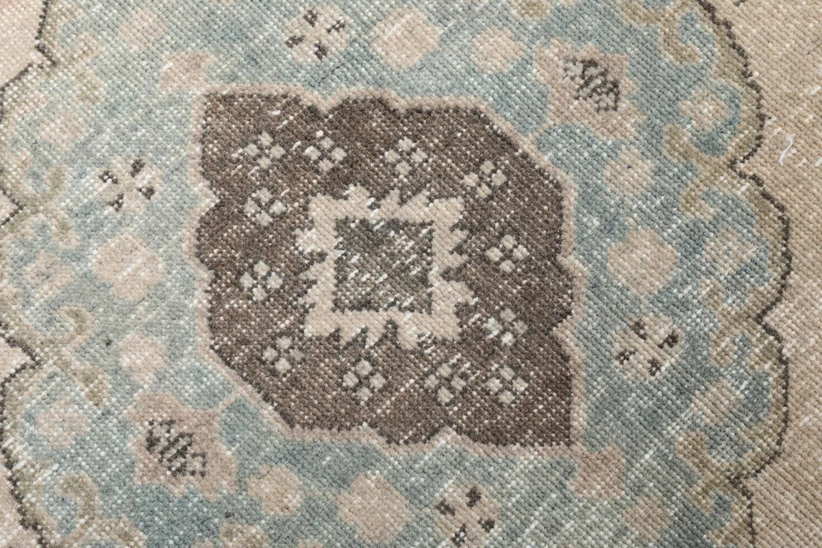 Tight detail of the intricate geometric patterns within a blue medallion.
