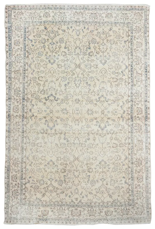 Full top view of the beige vintage Anatolian rug with blue and brown floral patterns