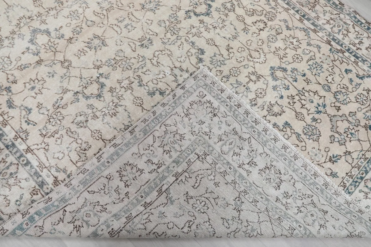 View of the back of the hand-knotted rug, revealing the cotton foundation and knotting