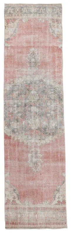 Full overhead view of the vintage rose and gray Anatolian runner rug on a white background.