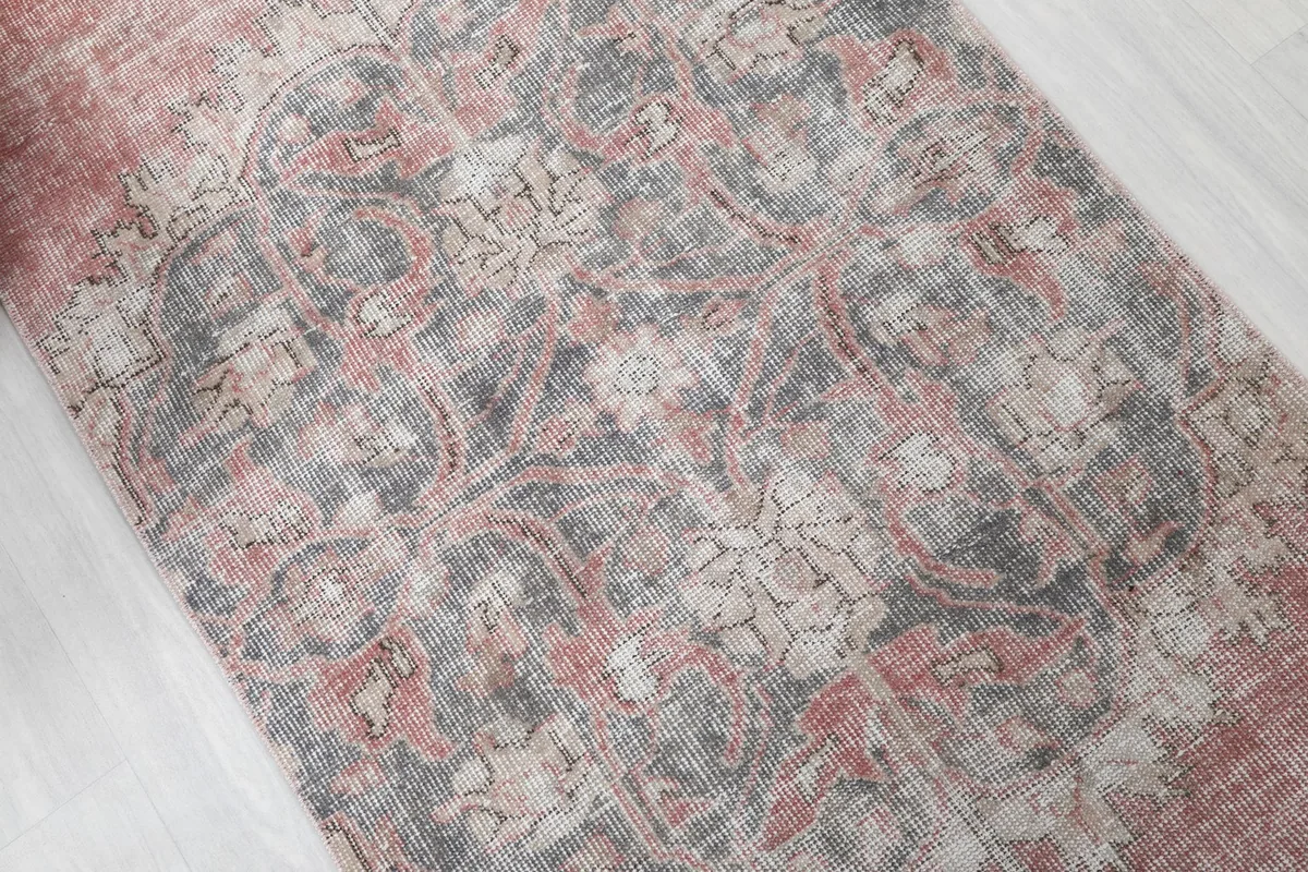 Close-up of the central gray medallion motif with floral accents.