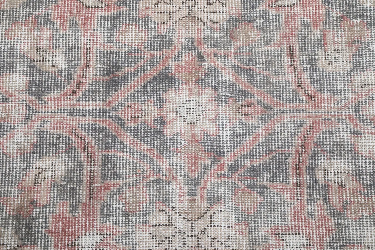 Detailed view of the hand-knotted wool pile, showing texture and color variations.