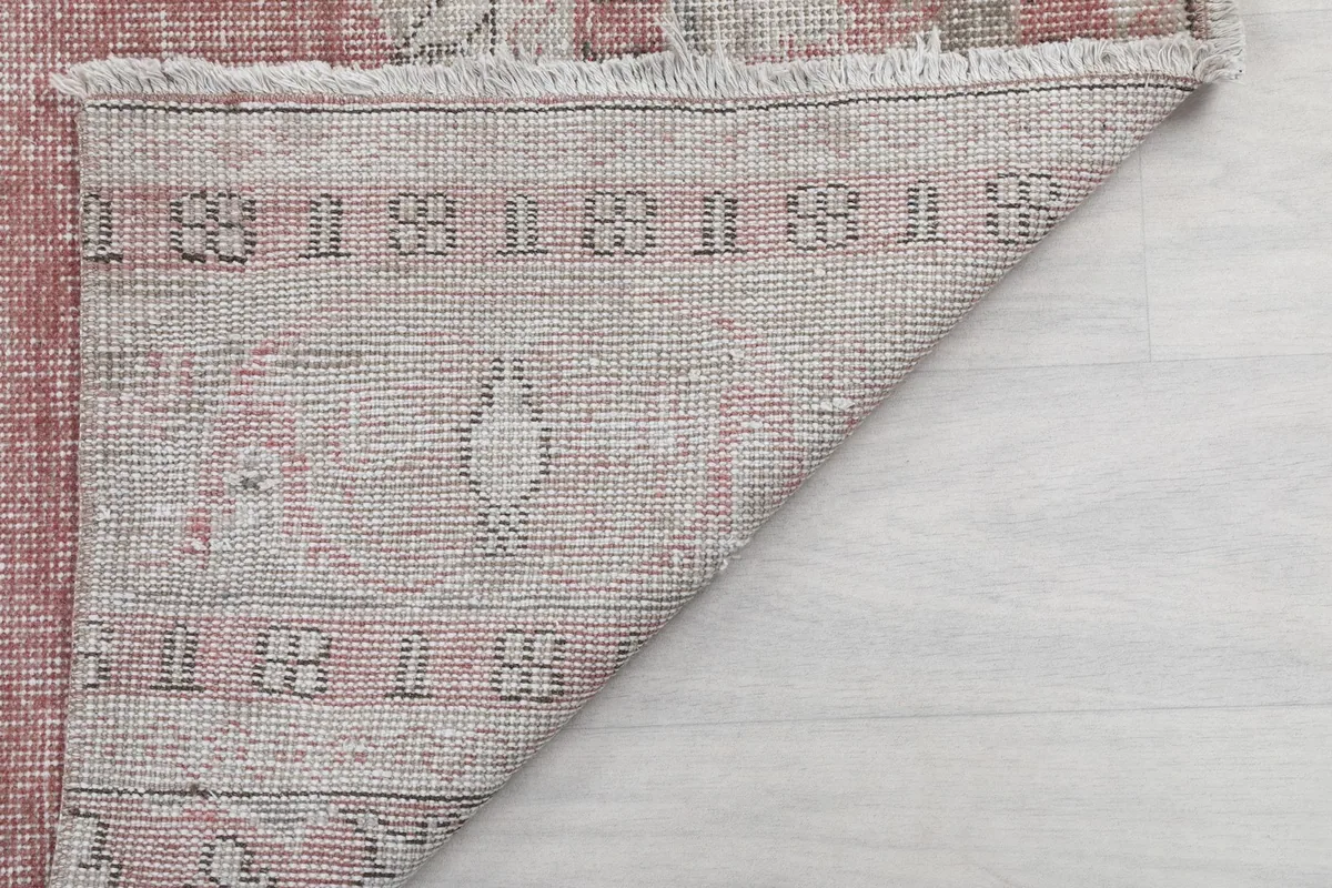Underside of the rug, showing the hand-knotted construction and fringe.